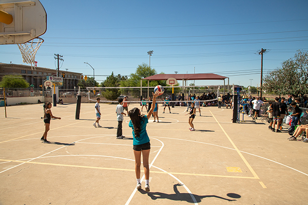 Students play volleyball on the outdoor court
