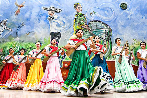 A group of girls in colorful folklorico dresses