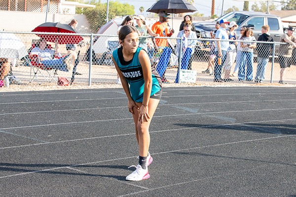 A girl waits on the track for her turn during the relay race