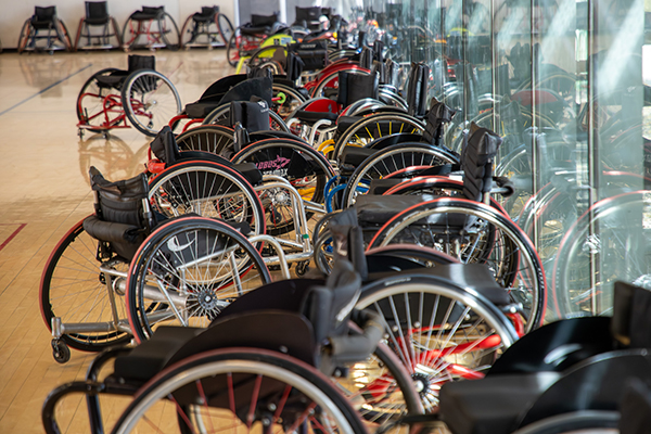 A group of wheelchairs in the gym