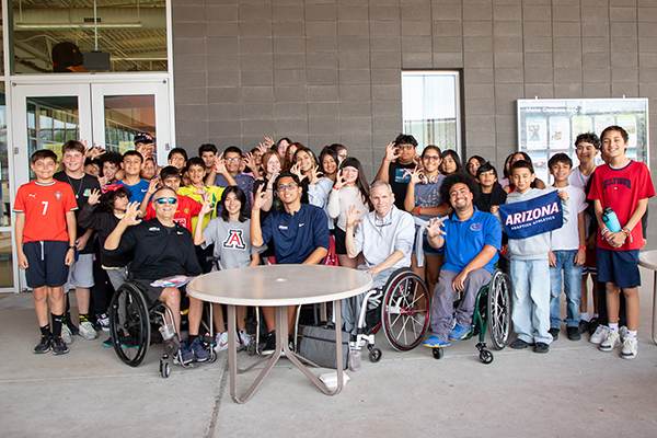 A group photo of students and their adaptive sports coaches