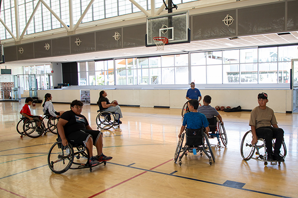 Students wheel around the basketball court