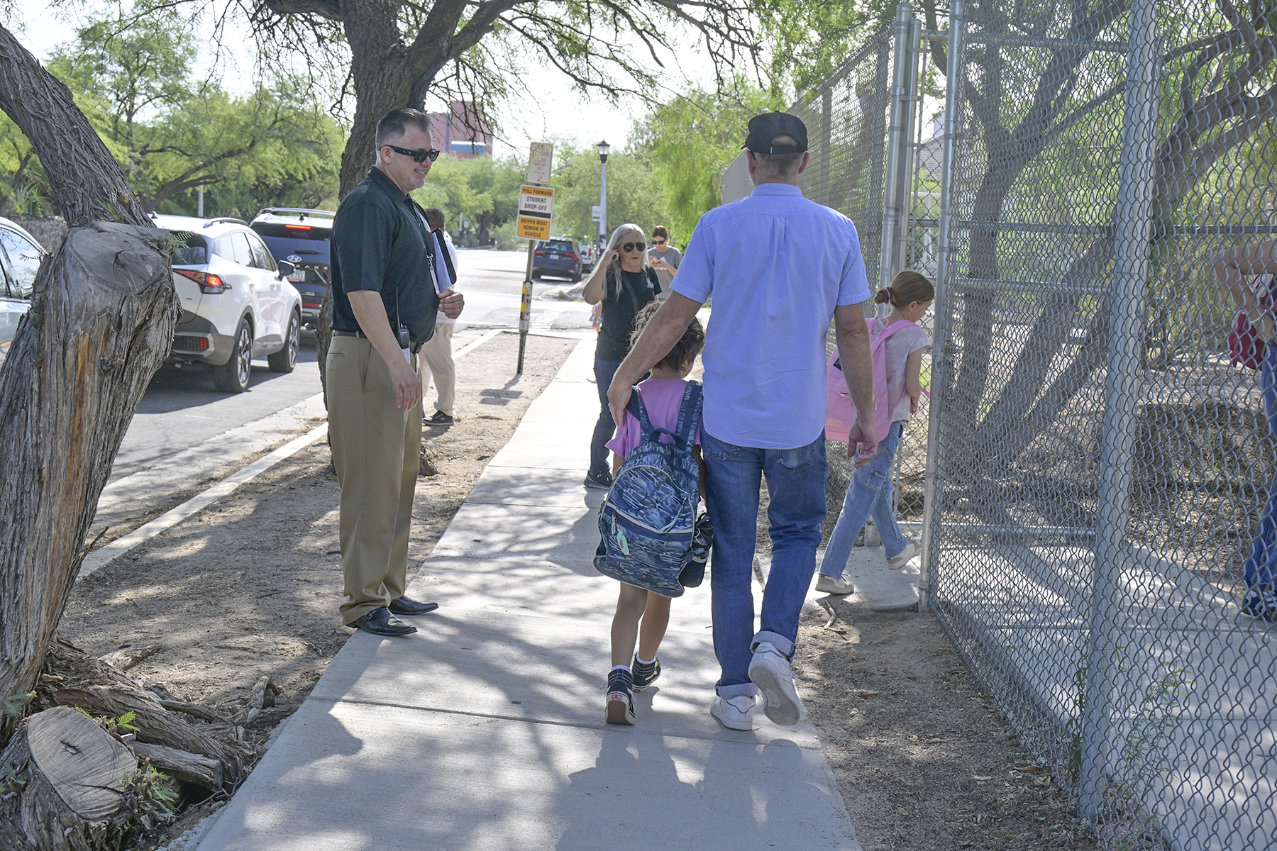 Parents walk with their kids to school
